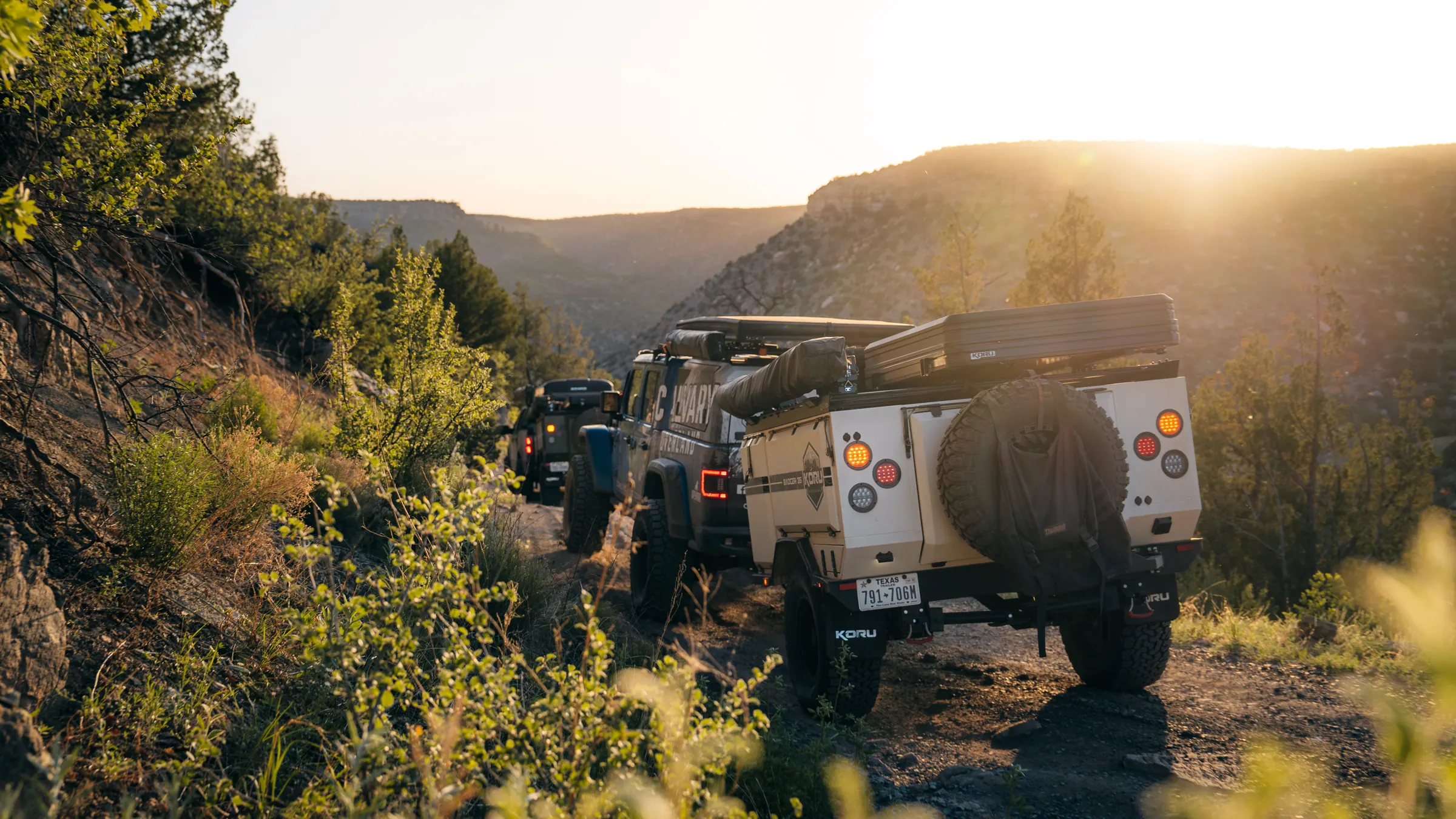 A Koru Badger 35 overland trailer at sunset in a desert canyon