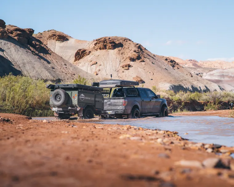 Truck and Koru trailer crossing a shallow river